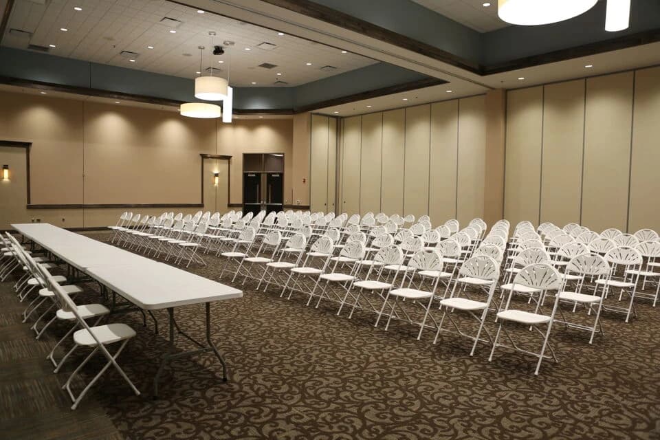 An interior hall set with rows of chairs for a session